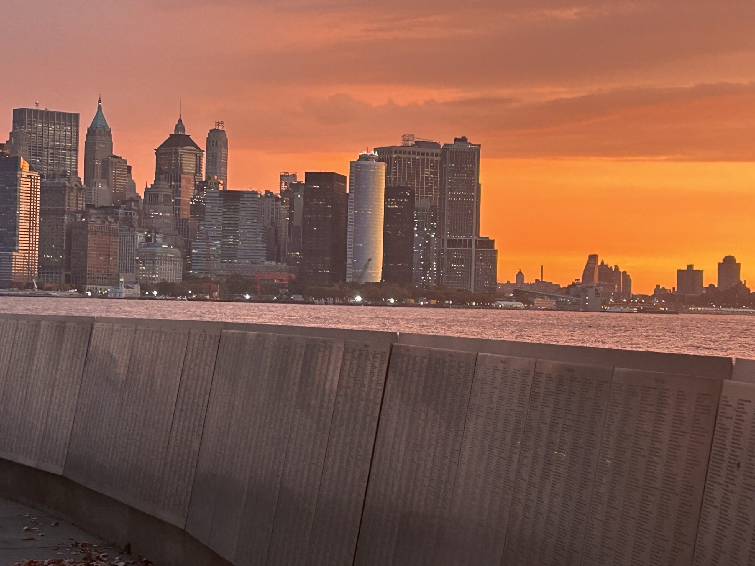 Wall of Honor on Ellis Island with NYC Skyline